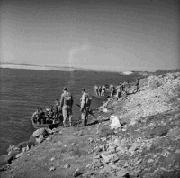 2nd NZEF 6th Infantry Brigade alongside the Nile, Egypt, undergoing training using collapsible boats for river crossings.  Taken by an unidentified photographer circa 1941.