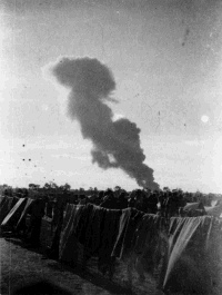 Air force raid on Benghazi Harbour, Libya, as seen from prison camp 116 (Palm Tree).  Photograph taken by H R Dixon, circa 1942.  Note on back of file print reads 