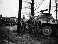 American Troops, and United States armoured car at prisoner camp Oflag 79,  Braunschweig, Germany, circa 12th of April 1945. German guards, now prisoner of war, are to the left.  Photograph taken by I McD Matheson.
