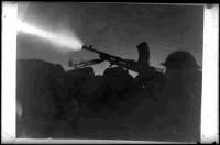 A Bren gun firing on a fixed line at night, Libya. Photograph taken by G Silk, 26 December 1941.