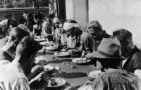 Escapees from a prisoner of war camp, eating their first meal after reaching Switzerland, September, 1943. Photographed by Peter Watson Bates.