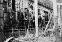 Prisoners of war queueing for midday soup, Tirol, Austria, January, 1945.  Photographed by H G Harvey. Caption on front of file print reads: 