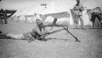 View of Waiouru Army Training Camp, shows soldier using a Bren Gun on a tripod mount. Photograph taken by Errol Morton ca 1933.