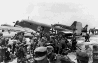 German paratroopers wating to embark on JU-52 Transport Aircraft for the invasion of Crete. Note on back reads: Captured German Film.