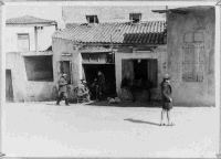 Street Scene with buildings and an unidentified group. Galatas, Crete. Photograph taken by Corporal Goodallon. 24 June, 1941.