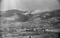 A photograph taken from the headquarters of the 6th New Zealand Brigade, showing New Zealand `stonks' falling on the strongly held German positions on one of the ridges guarding the approach to Florence. To the left is the location of the village of San Michele. Taken by George Kay on 2 August 1944.