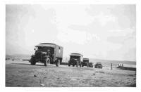 Convoy of army ambulances in Egypt during World War 2. Shows them moving patients from the 4th Field Ambulance camp hospital in Maadi to the 4th New Zealand General Hospital in Helwan. Photograph taken in Maadi between 24-31 July 1940.