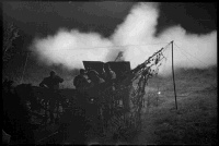 New Zealand 25 pdr firing a field gun at night near Sora, Italy. Photographed by George F Kaye on 1 June 1944