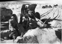 New Zealand soldiers of 6 New Zealand Field Regiment and 4.5 howitzer during manoeuvres at Helwan, Egypt, World War 2. Photograph taken by B C Mills, 15 Jan 1941. Note on back of file print reads: Taking it easy Helwan on manoeuvres