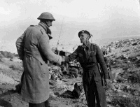 Relief of Tobruk. Join up of 8th Army and Tobruk garrison, 27 November, 1941. Lieutenant-Colonel S F Hartnell is on the left. British official photograph. Notes on back of file print include 'Prob 19 NZ Bn [?] at Ed Duda. NZ Officer - Lt/Col S F Hartnell. Tobruk - Link up - 2 Libyan Campaign. 19 NZ Bn - Ed Duda. 32 Army Tank Bde - Ed Duda.'