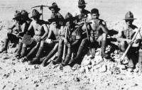 Soldiers of the 1st Contingent taking a break from digging of weapon pits training, Egypt. Taken by an unidentified photographer, circa 1941.