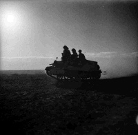 Soldiers travelling on a Bren Carrier in the Western Desert, Egypt, on a dawn reconnaissance.