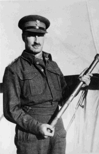 Stephen Cyril Ettick Weir in army uniform, in late 1941 or early 1942. He holds an artillery rammer. The artillery rammer was picked from the battlefield at Sidi Resegh by Brigadier Latham. It was later inscribed and presented to Freyberg by Latham. It is now housed in the Army Museum, Waiouru. Inscribed - Mount verso.