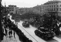 A scene in Monfalcone, on the 3rd of May, 1945, shortly after its liberation by troops of the New Zealand Division. Tanks of the 4th New Zealand Armoured Regiment, are passing through a street lined with crowds.  Photograph taken by George Kaye.