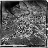 Aerial view of Cassino, Italy, during World War II. (Marked areas show where New Zealand troops were stationed?). Probably a Royal Air Force photograph.  List of places visible: Castle Hill; Hotel des Roses; Continental Hotel; Botanical Gardens; Nunnery; Church and crypt; arrow-route.