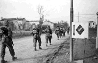 Infantrymen of 26th Battalion with full fighting equipment, on the outskirts of Gambettola, on the way to the front line, Italy, 19 October 1944.  Photographed by George Kaye.