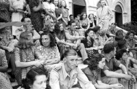 Officers of the 22nd NZ Battalion and their guests listen to the Battalion Pipe Band at a dance held by the Battalion at a Baron's homestead overlooking the city of Trieste.  Photographed by George Kay in May 1945.