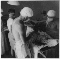 Amputation operation at the 5th New Zealand Field Ambulance main dressing station in Sora, Italy, circa 3 June 1944. Patient and medical personnel unidentified.  Photograph taken by K G Killoh.