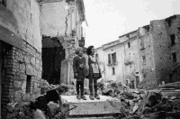 Children standing atop ruins of the demolished village of Gessopalena, Italy, which was near the Italian front.  Taken by George Kaye on 16 December 1943.