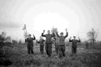 German prisoners of war carrying a white flag as the attack on the Senio River bears results.  Photograph taken by George Kaye on the 9th of April, 1945.