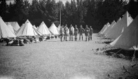 View of Waiouru Army Training Camp, showing a group of soldiers between two lines of tents. Photograph taken by Errol Cliff Morton ca 1933.