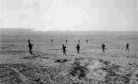 Under a barrage of smoke and high explosive shells, New Zealand infantrymen advance to the attack in realistic excercises.