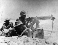 NZ Machine Gunners in action at Minqar Qaim, Egypt. Photograph taken by H Paton in either June or July 1942.
