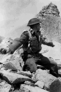 A soldier at the Cassino battlefront, Italy. This is a reconstructed battle scene.  Taken by George Kaye on 5 April 1944.