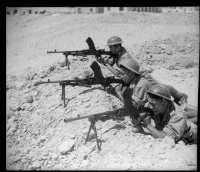 Photograph showing three members of the 28th Battalion training with Bren guns in Maadi.  Taken circa 1943 by an unidentified photographer.
