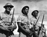 Three members of the Maori Battalion in the Western Desert, Egypt.  From left to right: P Clarke, T Bryers and W H Cooper.  Photographer unidentified.